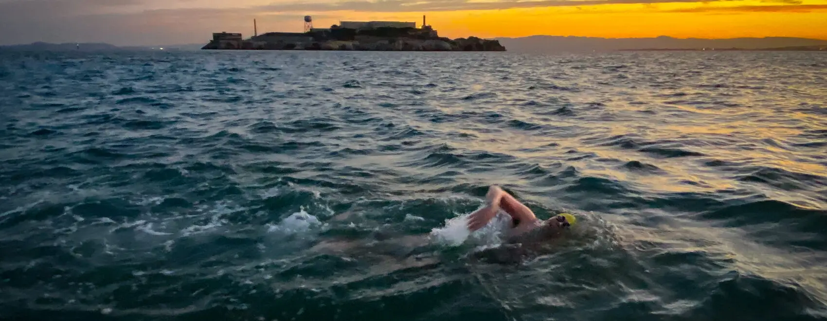 Andrew Packer swimming at dawn during the return leg of the Round-Trip Angel Island marathon swim in San Francisco Bay.