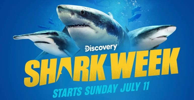 Promotional image for Discovery Channel’s Shark Week featuring three great white sharks and bold yellow text that reads “Shark Week – Starts Sunday July 11” on a blue ocean background.